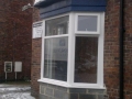 Ground floor bay window being repaired following impact damage